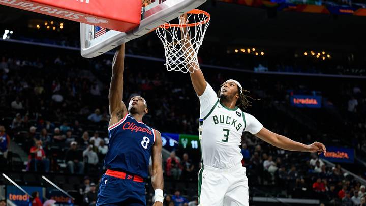 Mar 23, 2026; Inglewood, California, USA; Los Angeles Clippers guard Kris Dunn (8) shoots the ball past Milwaukee Bucks center Myles Turner (3) during the first half at Intuit Dome. Mandatory Credit: William Liang-Imagn Images