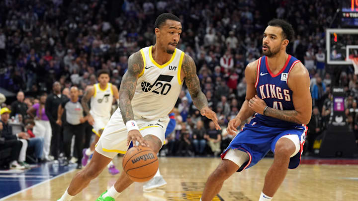 Nov 16, 2024; Sacramento, California, USA; Utah Jazz forward John Collins (20) dribbles against Sacramento Kings forward Trey Lyles (41) during the fourth quarter at Golden 1 Center. Mandatory Credit: Darren Yamashita-Imagn Images
