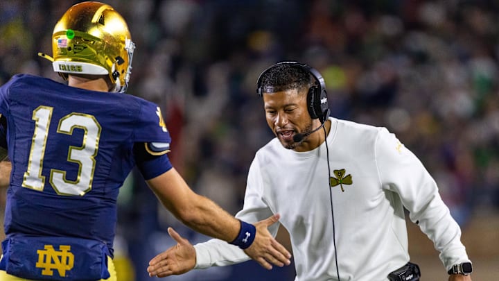Oct 18, 2025; South Bend, Indiana, USA; Notre Dame Fighting Irish head coach Marcus Freeman celebrates with quarterback CJ Carr (13) during the first half against the Southern California Trojans at Notre Dame Stadium. Mandatory Credit: Michael Caterina-Imagn Images