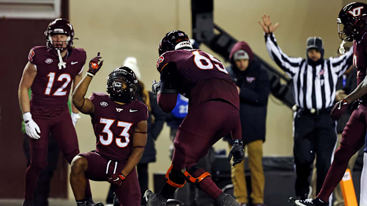 Nov 30, 2024; Blacksburg, Virginia, USA; Virginia Tech Hokies running back Bhayshul Tuten (33) celebrates after scoring a touchdown during the fourth quarter against the Virginia Cavaliers at Lane Stadium. Mandatory Credit: Peter Casey-Imagn Images Nov 30, 2024; Blacksburg, Virginia, USA; Virginia Tech Hokies running back Bhayshul Tuten (33) celebrates after scoring a touchdown during the fourth quarter against the Virginia Cavaliers at Lane Stadium. Mandatory Credit: Peter Casey-Imagn Images