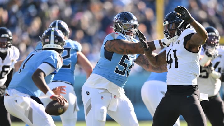 Nov 30, 2025; Nashville, Tennessee, USA; Tennessee Titans offensive tackle JC Latham (55) attempts to slow down Jacksonville Jaguars defensive end Josh Hines-Allen (41) during the first half at Nissan Stadium. Mandatory Credit: Steve Roberts-Imagn Images