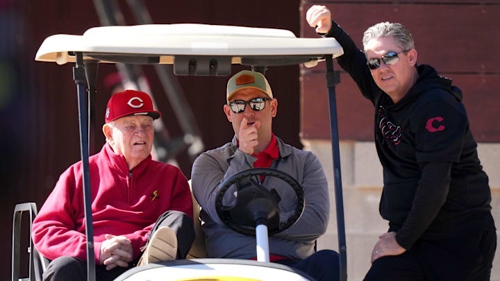 From left; Cincinnati Reds CEO Bob Castellini, president of baseball operations Nick Krall and senior vice president and general manager Brad Meador talk during spring training workouts , Monday, Feb. 19, 2024, at the team's spring training facility in Goodyear, Ariz.