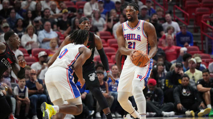 Apr 4, 2024; Miami, Florida, USA;  Philadelphia 76ers center Joel Embiid (21) hands the ball to