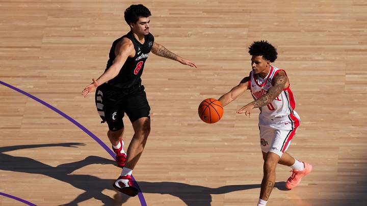 Oct 7, 2026; Mason, OH, USA;  Ohio State Buckeyes guard John Mobley Jr. (0) passes the ball against Cincinnati Bearcats forward Tyler Tejada (8) in the first half during the 2026 CareSource Invitational at the Lindner Family Tennis Center. Mandatory Credit: Aaron Doster-Imagn Images