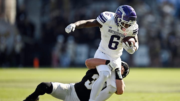 Nov 2, 2024; West Lafayette, Indiana, USA; Northwestern Wildcats running back Joseph Himon II (6) is tackled by Purdue Boilermakers defensive back Dillon Thieneman (31) during the second half at Ross-Ade Stadium. Mandatory Credit: Marc Lebryk-Imagn Images