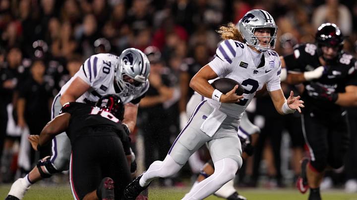 Sep 26, 2026; Cincinnati, Ohio, USA; Kansas State Wildcats quarterback Avery Johnson (2) runs with the ball against the Cincinnati Bearcats in the first half at Nippert Stadium. Mandatory Credit: Aaron Doster-Imagn Images Sep 26, 2026; Cincinnati, Ohio, USA; Kansas State Wildcats quarterback Avery Johnson (2) runs with the ball against the Cincinnati Bearcats in the first half at Nippert Stadium. Mandatory Credit: Aaron Doster-Imagn Images