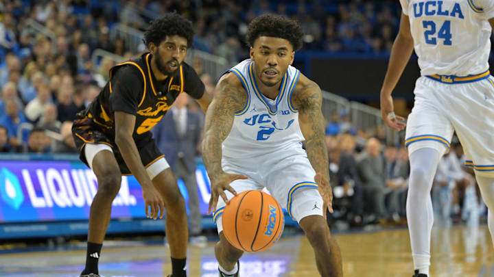 Dec 17, 2025; Los Angeles, California, USA;  UCLA Bruins guard Donovan Dent (2) is defended by Arizona State Sun Devils guard Moe Odum (5) as he drives to the basket in the first half at Pauley Pavilion presented by Wescom Financial. Mandatory Credit: Jayne Kamin-Oncea-Imagn Images 