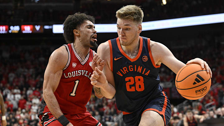 Jan 13, 2026; Louisville, Kentucky, USA;  Virginia Cavaliers forward Thijs de Ridder (28) dribbles against Louisville Cardinals guard J'vonne Hadley (1) during the first half at KFC Yum! Center. Mandatory Credit: Jamie Rhodes-Imagn Images