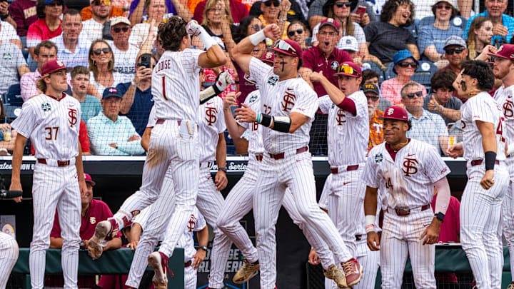 Jun 19, 2024; Omaha, NE, USA; Florida State Seminoles shortstop Alex Lodise (1) celebrates with teammates after hitting a home run against the Tennessee Volunteers during the seventh inning at Charles Schwab Field Omaha. Mandatory Credit: Dylan Widger-Imagn Images