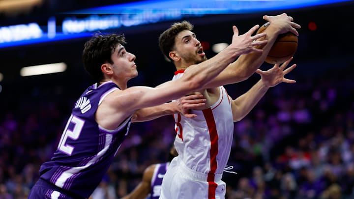 Dec 21, 2025; Sacramento, California, USA; Houston Rockets center Alperen Sengun (28) and Sacramento Kings center Maxime Raynaud (42) reach for a rebound during the second quarter at Golden 1 Center. Mandatory Credit: Sergio Estrada-Imagn Images