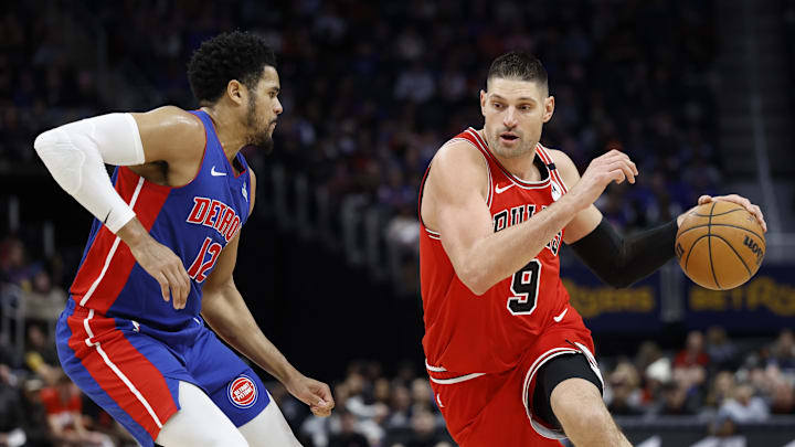 Feb 2, 2025; Detroit, Michigan, USA; Chicago Bulls center Nikola Vucevic (9) dribbles defended by Detroit Pistons forward Tobias Harris (12) in the first half at Little Caesars Arena. Mandatory Credit: Rick Osentoski-Imagn Images