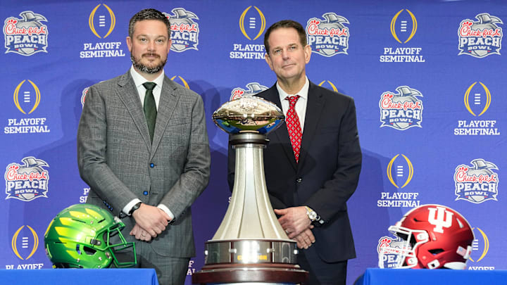 Oregon Ducks head coach Dan Lanning and Indiana Hoosiers head coach Curt Cignetti smile for a photo Thursday, Jan. 8, 2026, during a coaches' press conference ahead of the College Football Playoff Peach Bowl game at the College Football Hall of Fame in Atlanta.