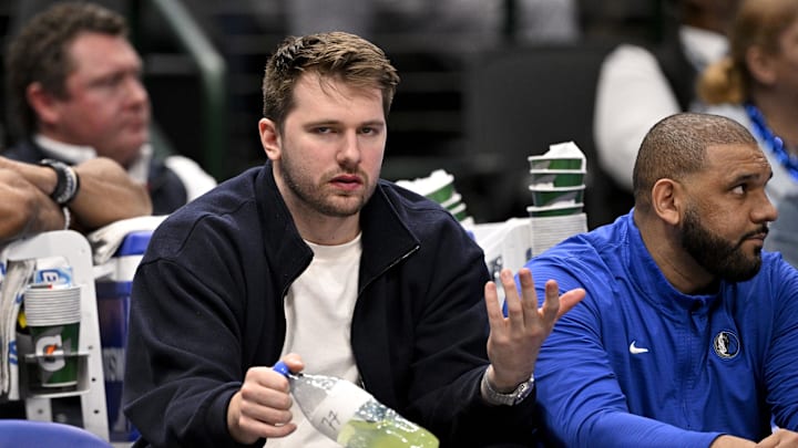 Jan 12, 2025; Dallas, Texas, USA; Dallas Mavericks guard Luka Doncic (77) reacts from the team bench during the second half of the game against the Denver Nuggets at the American Airlines Center. Mandatory Credit: Jerome Miron-Imagn Images