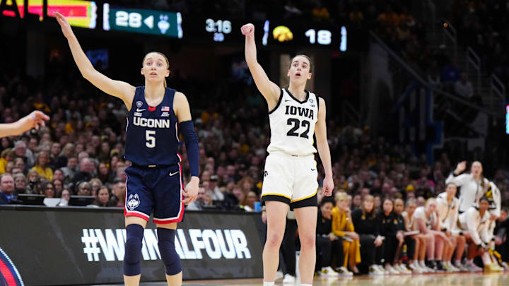 Apr 5, 2024; Cleveland, OH, USA; Iowa Hawkeyes guard Caitlin Clark (22) and Connecticut Huskies guard Paige Bueckers (5) react in the second quarter in the semifinals of the Final Four of the womens 2024 NCAA Tournament at Rocket Mortgage FieldHouse. Mandatory Credit: Kirby Lee-Imagn Images