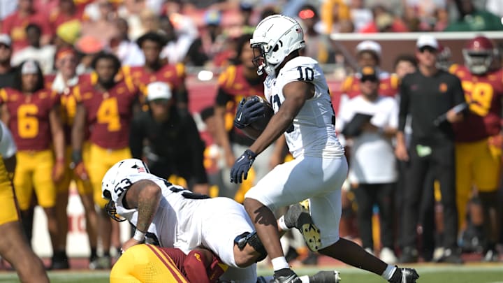 Penn State running back Nicholas Singleton carries the ball for a short gain in the first half against the USC Trojans at the Los Angeles Memorial Coliseum. Penn State running back Nicholas Singleton carries the ball for a short gain in the first half against the USC Trojans at the Los Angeles Memorial Coliseum.