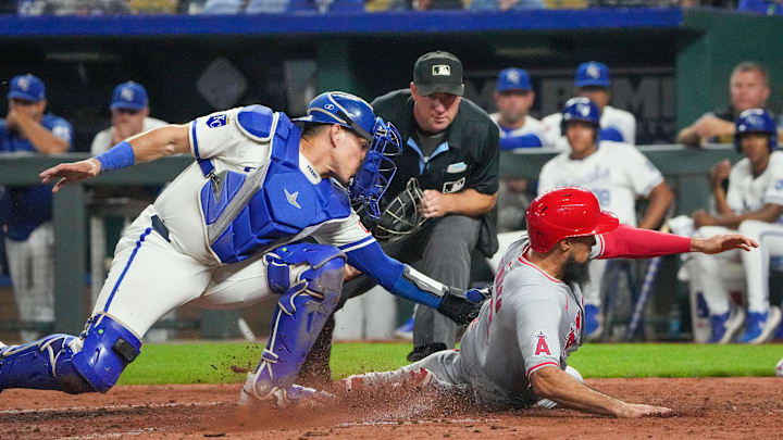 Aug 20, 2024; Kansas City, Missouri, USA; Kansas City Royals catcher Freddy Fermin (34) misses the tag as Los Angeles Angels third base Anthony Rendon (6) scores in the ninth inning  at Kauffman Stadium. Mandatory Credit: Denny Medley-Imagn Images