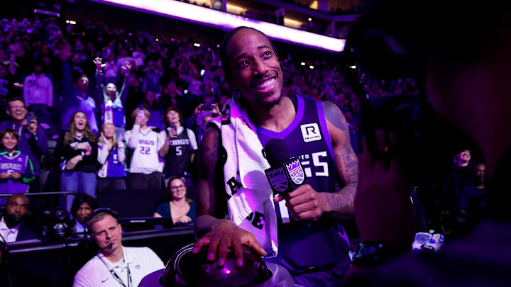 Oct 28, 2024; Sacramento, California, USA; Sacramento Kings forward DeMar DeRozan (10) lights the beam in celebration of their victory over the Portland Trail Blazers after the game at Golden 1 Center. Mandatory Credit: Sergio Estrada-Imagn Images