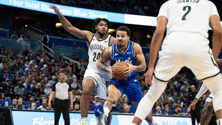 Mar 13, 2024; Orlando, Florida, USA; Orlando Magic guard Cole Anthony (50) drives to the basket against Brooklyn Nets guard Cam Thomas (24) in the fourth quarter at Kia Center. Mandatory Credit: Jeremy Reper-Imagn Images