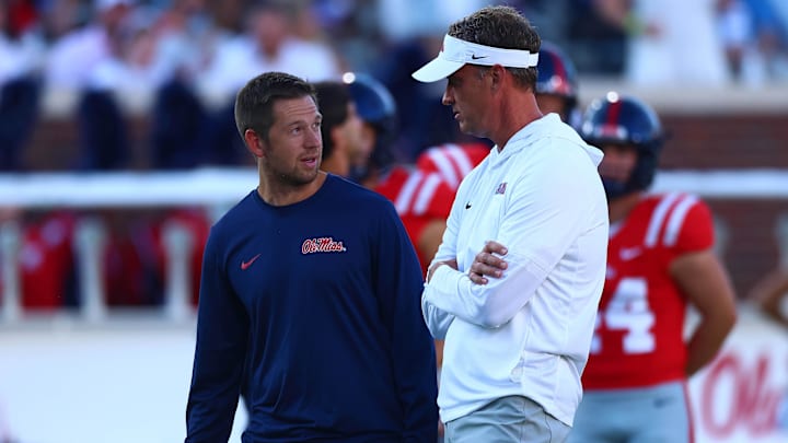 Aug 30, 2025; Oxford, Mississippi, USA; Mississippi Rebels head coach Lane Kiffin (right) talks with offensive coordinator Charlie Weis Jr. during warm ups prior to the game against the Georgia State Panthers at Vaught-Hemingway Stadium. Mandatory Credit: Petre Thomas-Imagn Images Aug 30, 2025; Oxford, Mississippi, USA; Mississippi Rebels head coach Lane Kiffin (right) talks with offensive coordinator Charlie Weis Jr. during warm ups prior to the game against the Georgia State Panthers at Vaught-Hemingway Stadium. Mandatory Credit: Petre Thomas-Imagn Images