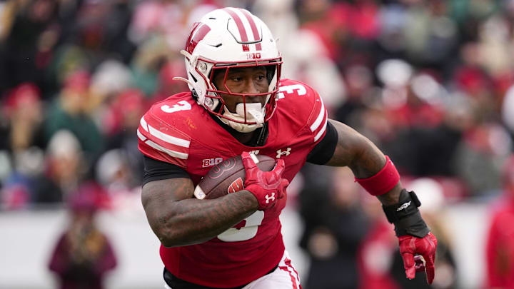 Nov 29, 2024; Madison, Wisconsin, USA; Wisconsin Badgers running back Tawee Walker (3) rushes with the football during the second quarter against the Minnesota Golden Gophers at Camp Randall Stadium. Mandatory Credit: Jeff Hanisch-Imagn Images Nov 29, 2024; Madison, Wisconsin, USA; Wisconsin Badgers running back Tawee Walker (3) rushes with the football during the second quarter against the Minnesota Golden Gophers at Camp Randall Stadium. Mandatory Credit: Jeff Hanisch-Imagn Images