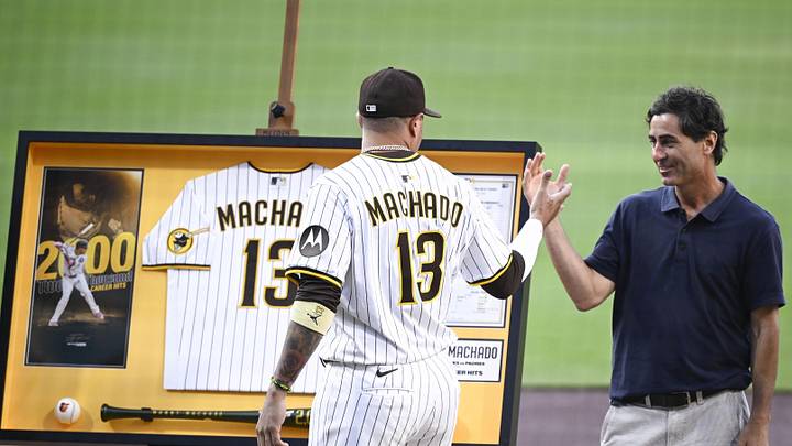 Jul 8, 2025; San Diego, California, USA; San Diego Padres third baseman Manny Machado (13) shakes hands with general manager A.J. Preller after receiving commemorative memorabilia recognizing his 2,000th hit before a baseball game against the Arizona Diamondbacks at Petco Park. Mandatory Credit: Denis Poroy-Imagn Images Jul 8, 2025; San Diego, California, USA; San Diego Padres third baseman Manny Machado (13) shakes hands with general manager A.J. Preller after receiving commemorative memorabilia recognizing his 2,000th hit before a baseball game against the Arizona Diamondbacks at Petco Park. Mandatory Credit: Denis Poroy-Imagn Images