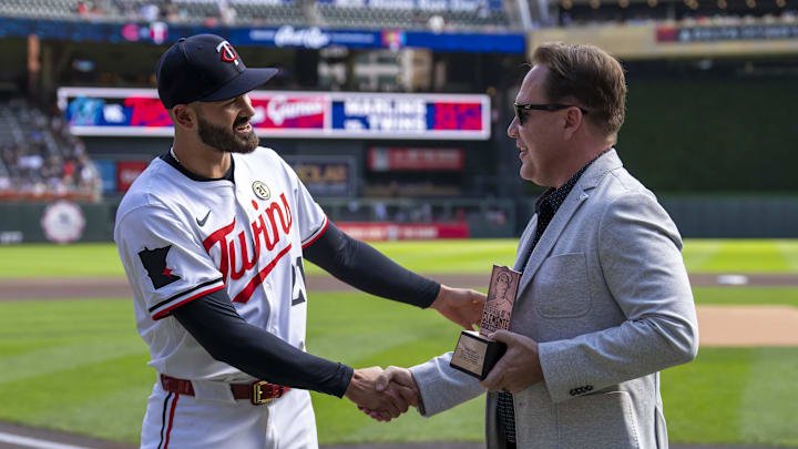 Sep 15, 2024; Minneapolis, Minnesota, USA; Minnesota Twins pitcher Pablo López (49) shakes hands with Minnesota Twins executive President of Baseball Operations Derek Falvey during pre game before a game against the Cincinnati Reds to receive the Roberto Clemente finalist award at Target Field. Mandatory Credit: Jesse Johnson-Imagn Images