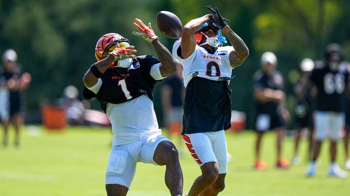 Cincinnati Bengals wide receiver Ja'marr Chase (1) and cornerback DJ Turner II (0) collide over a pass, resulting in a leg injury for Chase during Bengals training camp practice at the Paycor Stadium practice facility in downtown Cincinnati on Tuesday, Aug. 25, 2026. Cincinnati Bengals wide receiver Ja'marr Chase (1) and cornerback DJ Turner II (0) collide over a pass, resulting in a leg injury for Chase during Bengals training camp practice at the Paycor Stadium practice facility in downtown Cincinnati on Tuesday, Aug. 25, 2026.