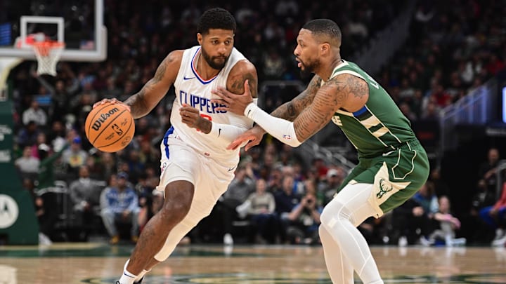 Mar 4, 2024; Milwaukee, Wisconsin, USA;  Los Angeles Clippers forward Paul George (13) drives for the basket against Milwaukee Bucks guard Damian Lillard (0) in the first quarter at Fiserv Forum. Mandatory Credit: Benny Sieu-Imagn Images
