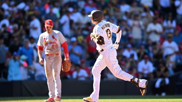 Sep 22, 2022; San Diego, California, USA; San Diego Padres third baseman Manny Machado (13) rounds the bases after hitting a home run during the eighth inning as St. Louis Cardinals third baseman Nolan Arenado (28) looks on at Petco Park. Mandatory Credit: Orlando Ramirez-Imagn Images