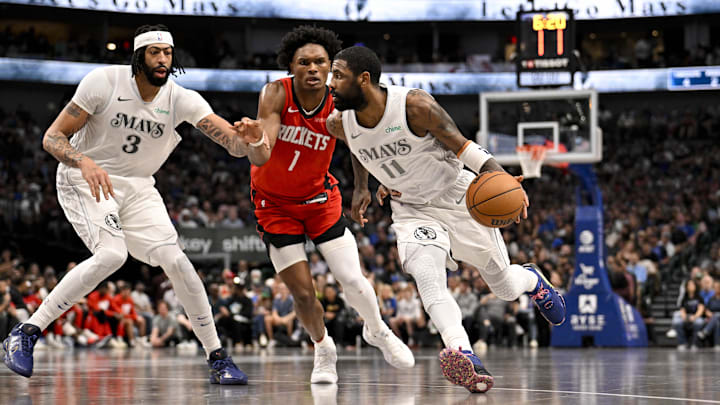 Feb 8, 2025; Dallas, Texas, USA; Dallas Mavericks guard Kyrie Irving (11) drives to the basket past forward Anthony Davis (3) and Houston Rockets forward Amen Thompson (1) during the second half at the American Airlines Center. Mandatory Credit: Jerome Miron-Imagn Images