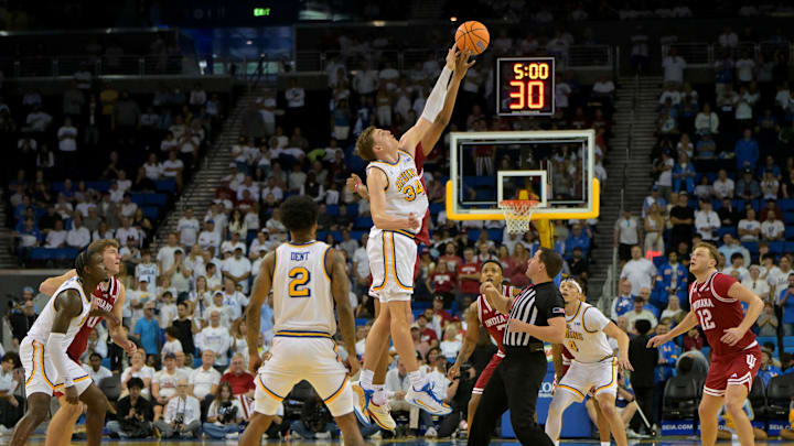 Jan 31, 2026; Los Angeles, California, USA;  UCLA Bruins forward Tyler Bilodeau (34) and Indiana Hoosiers forward Sam Alexis (4) tip off for the second overtime period of the game at Pauley Pavilion presented by Wescom Financial. Mandatory Credit: Jayne Kamin-Oncea-Imagn Images