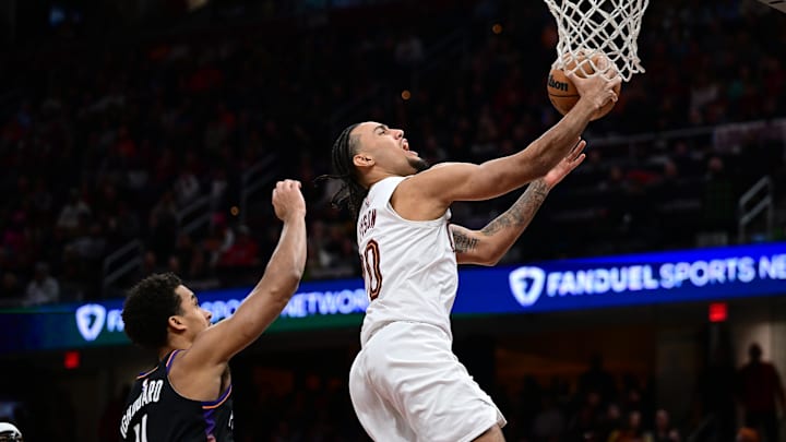 Dec 31, 2025; Cleveland, Ohio, USA; Cleveland Cavaliers guard Jaylon Tyson (20) goes to the basket against Phoenix Suns forward Oso Ighodaro (11) during the second half at Rocket Arena. Mandatory Credit: David Dermer-Imagn Images