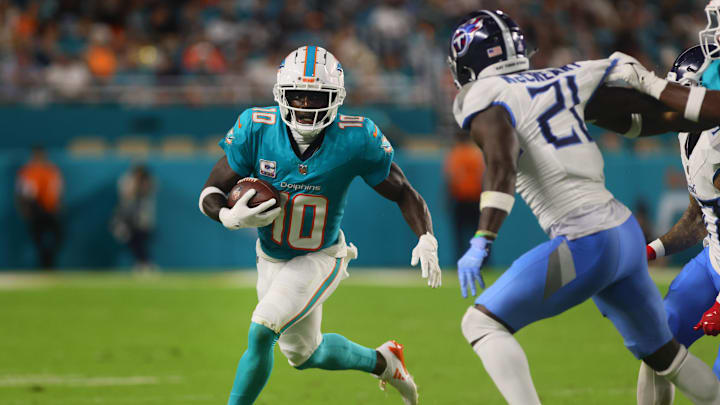 Miami Dolphins wide receiver Tyreek Hill (10) runs with the football against the Tennessee Titans during the third quarter at Hard Rock Stadium.