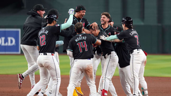 May 13, 2024; Phoenix, Arizona, USA; Arizona Diamondbacks shortstop Kevin Newman (18) celebrates with teammates after hitting a two RBI walk off single against the Cincinnati Reds during the ninth inning at Chase Field. Mandatory Credit: Joe Camporeale-USA TODAY Sports
