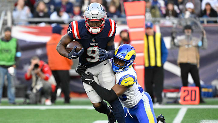 Nov 17, 2024; Foxborough, Massachusetts, USA; New England Patriots wide receiver Kayshon Boutte (9) is tackled by Los Angeles Rams safety Kamren Kinchens (26) during the second half at Gillette Stadium. Mandatory Credit: Eric Canha-Imagn Images