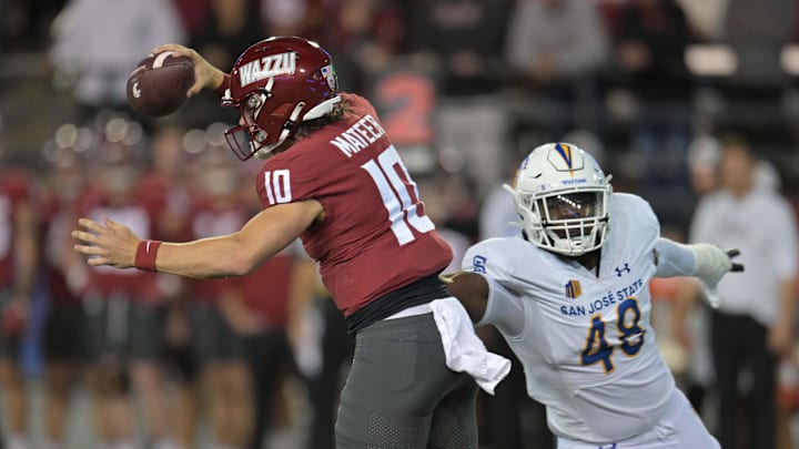 Sep 20, 2024; Pullman, Washington, USA; Washington State Cougars quarterback John Mateer (10) avoids San Jose State Spartans defensive lineman Dejon Roney (48) in the first half at Gesa Field at Martin Stadium. Mandatory Credit: James Snook-Imagn Images