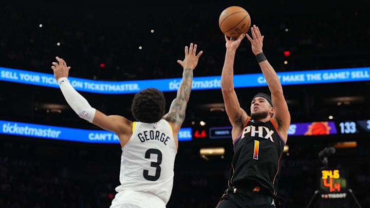 Phoenix Suns guard Devin Booker shoots over Utah Jazz guard Keyonte George. Phoenix Suns guard Devin Booker shoots over Utah Jazz guard Keyonte George.