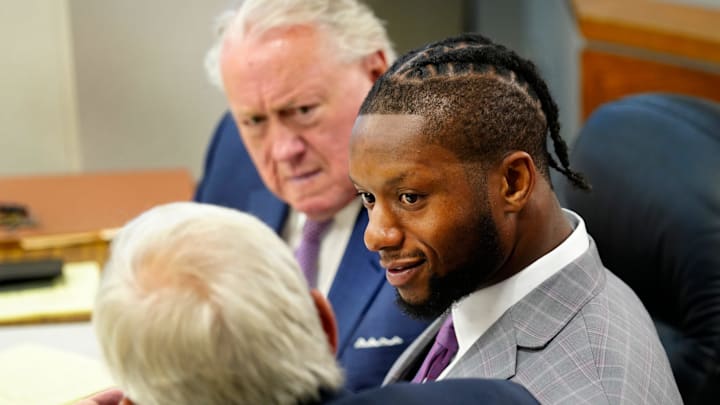 Cincinnati Bengals running back Joe Mixon confers with his attorney   s, Scott Croswell, center, and
