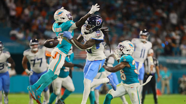 Sep 30, 2024; Miami Gardens, Florida, USA; Tennessee Titans wide receiver DeAndre Hopkins (10) jumps but cannot make a catch against Miami Dolphins cornerback Kader Kohou (4) and cornerback Storm Duck (36) during the second quarter at Hard Rock Stadium. Mandatory Credit: Sam Navarro-Imagn Images