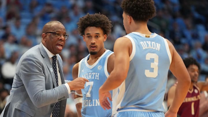Dec 30, 2025; Chapel Hill, North Carolina, USA; North Carolina Tar Heels head coach Hubert Davis with guard Seth Trimble (7) and guard Derek Dixon (3) in the second half at Dean E. Smith Center. Mandatory Credit: Bob Donnan-Imagn Images