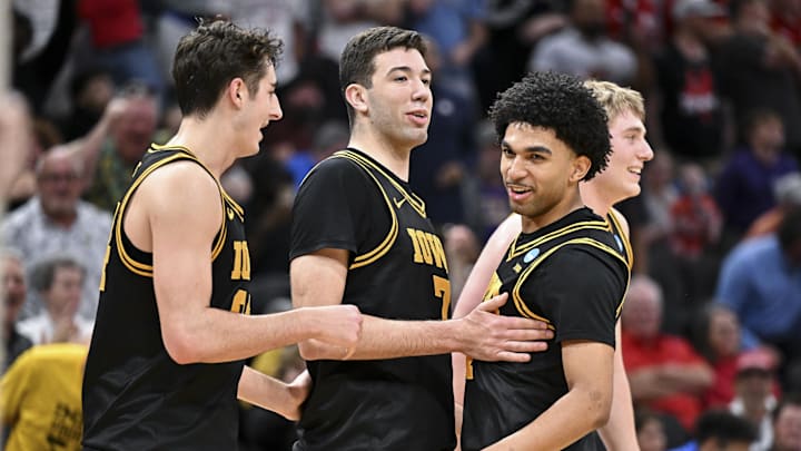 Mar 26, 2026; Houston, TX, USA; Iowa Hawkeyes forward Alvaro Folgueiras (7), guard Kael Combs (11) and guard Tate Sage (24) reacts against the Nebraska Cornhuskers during a Sweet Sixteen game of the South Regional of the men's 2026 NCAA Tournament at Toyota Center. Mandatory Credit: Maria Lysaker-Imagn Images