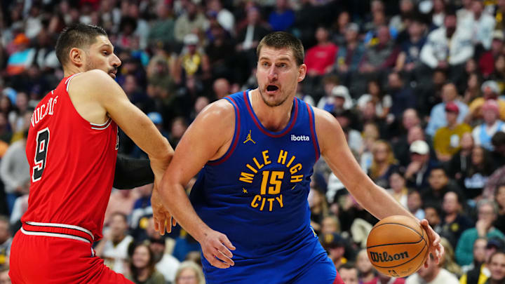  Denver Nuggets center Nikola Jokic (15) drives past Chicago Bulls center Nikola Vucevic (9) in the second half at Ball Arena. Mandatory Credit: Ron Chenoy-Imagn Images
