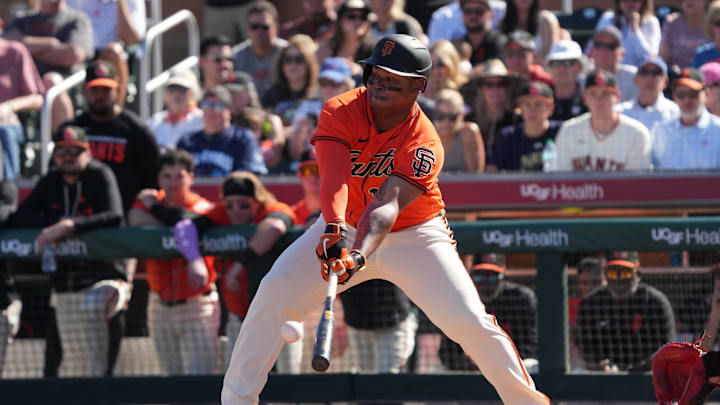 Feb 22, 2026; Scottsdale, Arizona, USA; San Francisco Giants designated hitter Rafael Devers (16) hits against the Chicago Cubs in the third inning at Scottsdale Stadium. Mandatory Credit: Rick Scuteri-Imagn Images