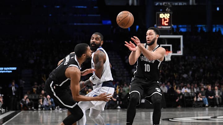Feb 6, 2024; Brooklyn, New York, USA; Brooklyn Nets guard Ben Simmons (10) passes the ball to Brooklyn Nets forward Mikal Bridges (1) as Dallas Mavericks guard Kyrie Irving (11) defends during the third quarter at Barclays Center. Mandatory Credit: John Jones-Imagn Images
