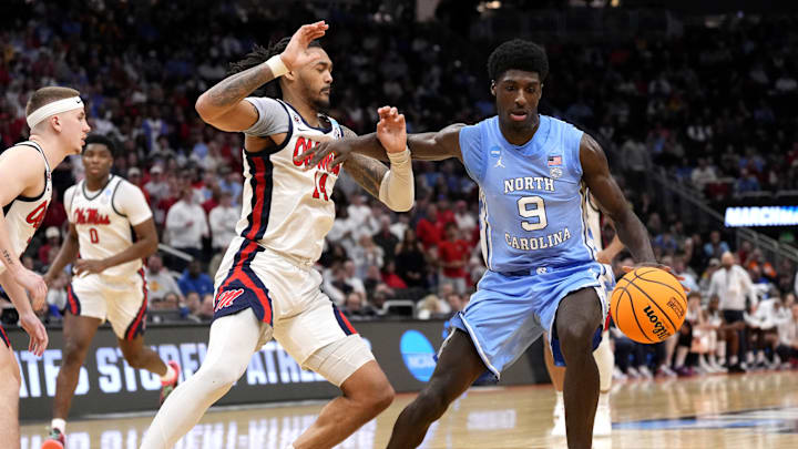 Mar 21, 2025; Milwaukee, WI, USA; North Carolina Tar Heels guard Drake Powell (9) drives against Mississippi Rebels guard Dre Davis (14) during the second half of a first round NCAA men’s tournament game at Fiserv Forum. Mandatory Credit: Jeff Hanisch-Imagn Images