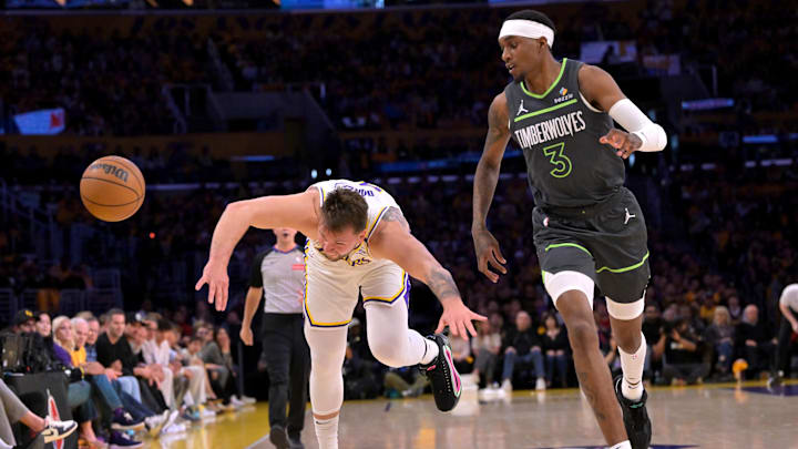 Apr 19, 2025; Los Angeles, California, USA: Los Angeles Lakers guard Luka Doncic (77) is fouled by Minnesota Timberwolves forward Jaden McDaniels (3) in the first quarter at Crypto.com Arena. Mandatory Credit: Jayne Kamin-Oncea-Imagn Images Apr 19, 2025; Los Angeles, California, USA: Los Angeles Lakers guard Luka Doncic (77) is fouled by Minnesota Timberwolves forward Jaden McDaniels (3) in the first quarter at Crypto.com Arena. Mandatory Credit: Jayne Kamin-Oncea-Imagn Images