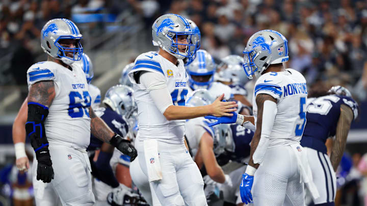 Oct 13, 2024; Arlington, Texas, USA;  Detroit Lions running back David Montgomery (5) celebrates with Detroit Lions quarterback Jared Goff (16) after scoring a touchdown during the first half against the Dallas Cowboys at AT&T Stadium. Mandatory Credit: Kevin Jairaj-Imagn Images