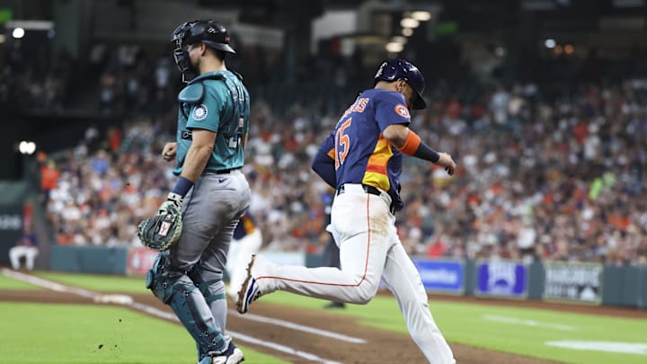 Houston Astros third baseman Isaac Paredes (15) scores a run past Seattle Mariners catcher Cal Raleigh (29) during the third inning at Daikin Park on May 25. Houston Astros third baseman Isaac Paredes (15) scores a run past Seattle Mariners catcher Cal Raleigh (29) during the third inning at Daikin Park on May 25.