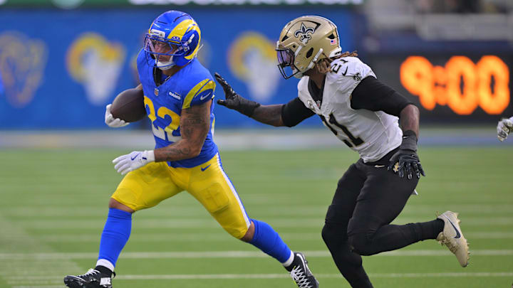 Nov 2, 2025; Inglewood, California, USA; Los Angeles Rams running back Blake Corum (22) carries the ball as New Orleans Saints safety Justin Reid (21) defends during the second half at SoFi Stadium. Mandatory Credit: Jayne Kamin-Oncea-Imagn Images