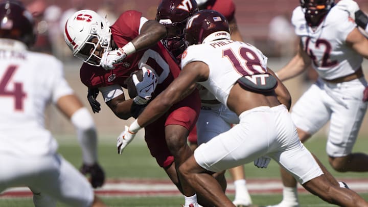 Oct 5, 2024; Stanford, California, USA; Stanford Cardinal running back Micah Ford (20) runs with the football against Virginia Tech Hokies safety Mose Phillips III (18) during the first quarter at Stanford Stadium. Mandatory Credit: Stan Szeto-Imagn Images Oct 5, 2024; Stanford, California, USA; Stanford Cardinal running back Micah Ford (20) runs with the football against Virginia Tech Hokies safety Mose Phillips III (18) during the first quarter at Stanford Stadium. Mandatory Credit: Stan Szeto-Imagn Images